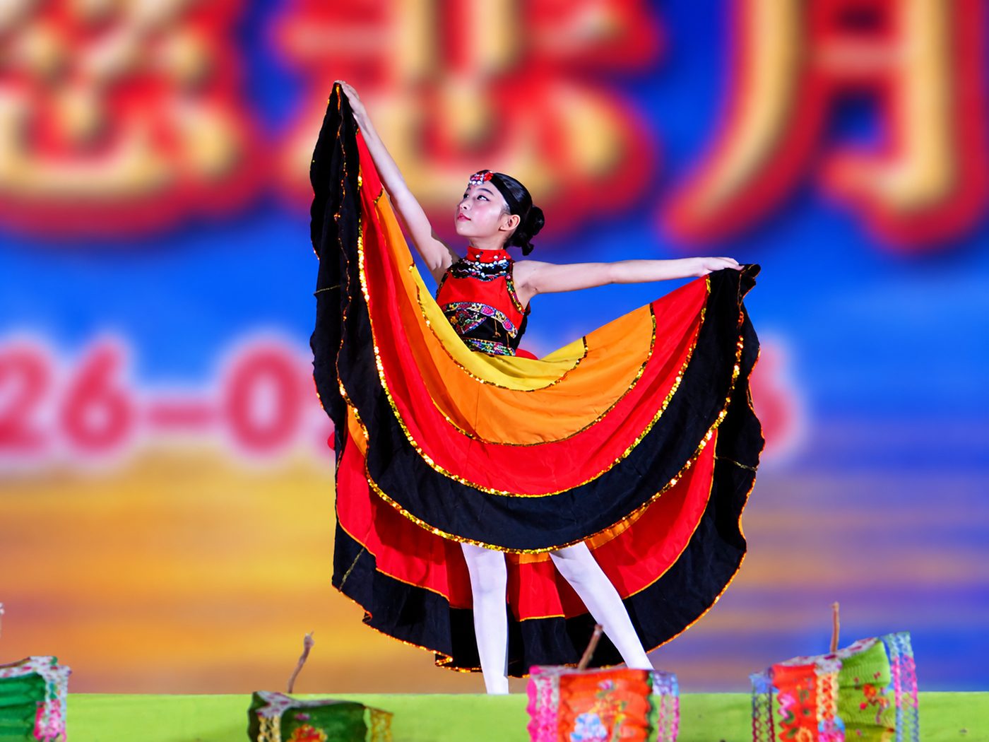 A solo dancer spreads her skirt like wings
